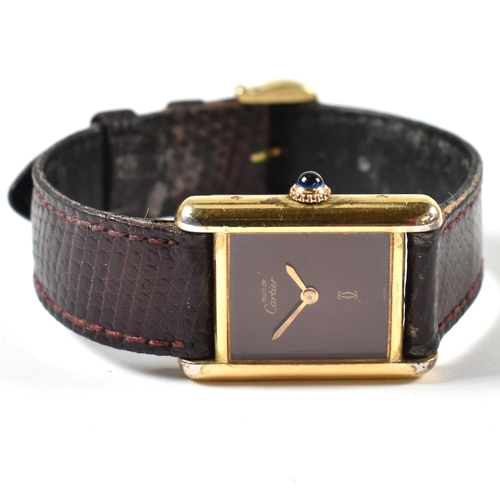 31A - Vintage Must De Cartier tank watch . The watch having a rectangular burgundy dial in a gold plated s... 