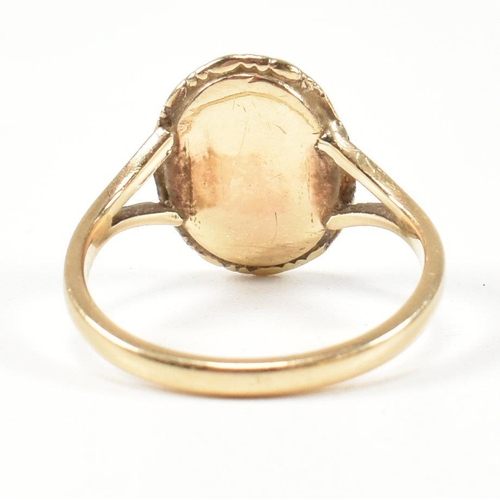 419 - A 19th century gold cameo ring. The ring set with a carved shell cameo of a figure in a closed back ... 