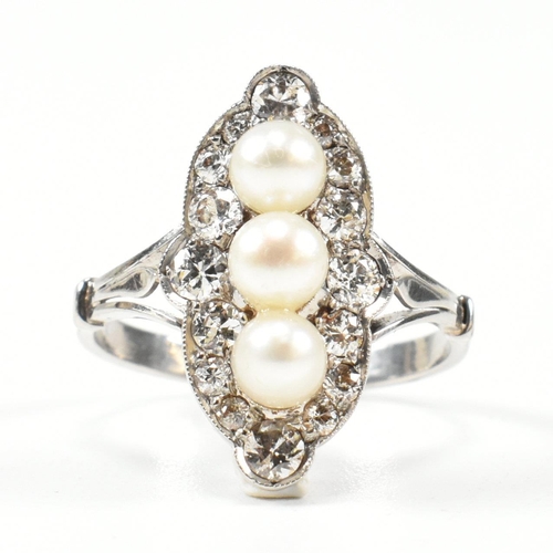 427 - A pearl and diamond marquise ring. The ring set with a line of pearls, framed by round brilliant cut... 