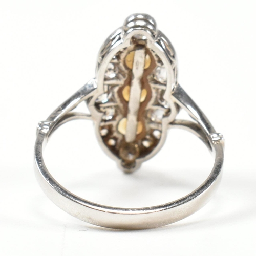 427 - A pearl and diamond marquise ring. The ring set with a line of pearls, framed by round brilliant cut... 