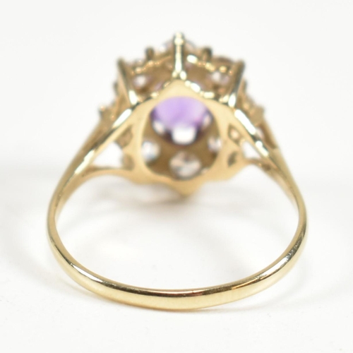 87 - A hallmarked 9ct gold, amethyst and white stone cluster ring. The ring having a central oval cut ame... 