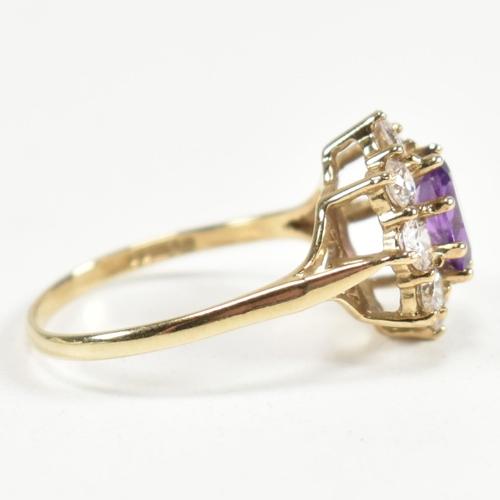 87 - A hallmarked 9ct gold, amethyst and white stone cluster ring. The ring having a central oval cut ame... 