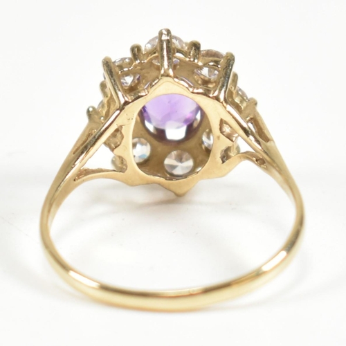 87 - A hallmarked 9ct gold, amethyst and white stone cluster ring. The ring having a central oval cut ame... 