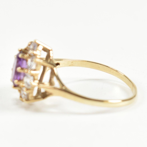 87 - A hallmarked 9ct gold, amethyst and white stone cluster ring. The ring having a central oval cut ame... 