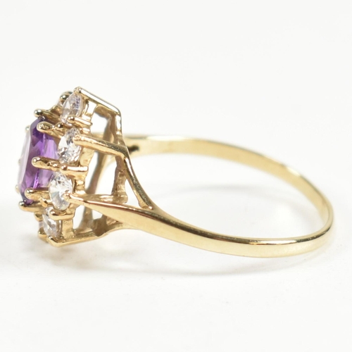 87 - A hallmarked 9ct gold, amethyst and white stone cluster ring. The ring having a central oval cut ame... 