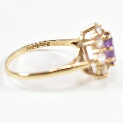 87 - A hallmarked 9ct gold, amethyst and white stone cluster ring. The ring having a central oval cut ame... 