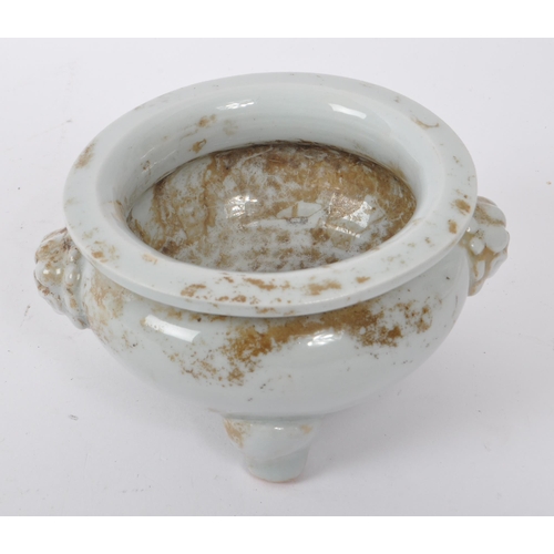 100 - A small 20th Century Chinese white porcelain censer bowl of squat form upon three legs having dragon... 