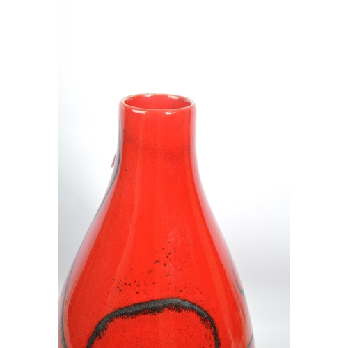 101 - A large ceramic contemporary mottled glazed red vase tapering to top having organic fine black swirl... 