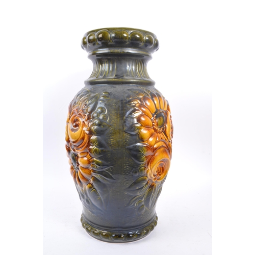 103 - A large 20th century West German vase. The vase having green and yellow colourway with relief sunflo... 