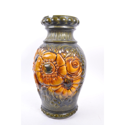 103 - A large 20th century West German vase. The vase having green and yellow colourway with relief sunflo... 