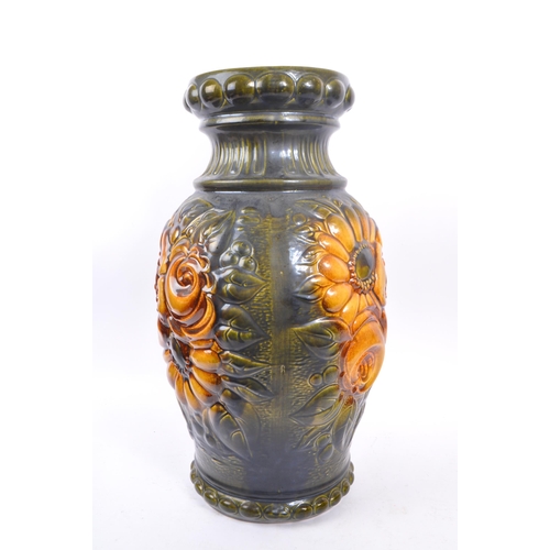 103 - A large 20th century West German vase. The vase having green and yellow colourway with relief sunflo... 