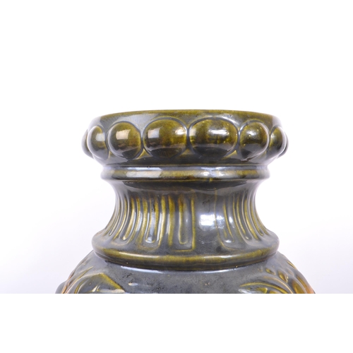 103 - A large 20th century West German vase. The vase having green and yellow colourway with relief sunflo... 