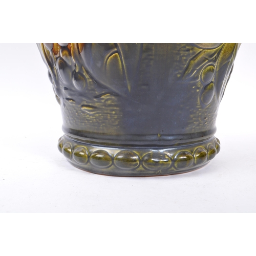 103 - A large 20th century West German vase. The vase having green and yellow colourway with relief sunflo... 