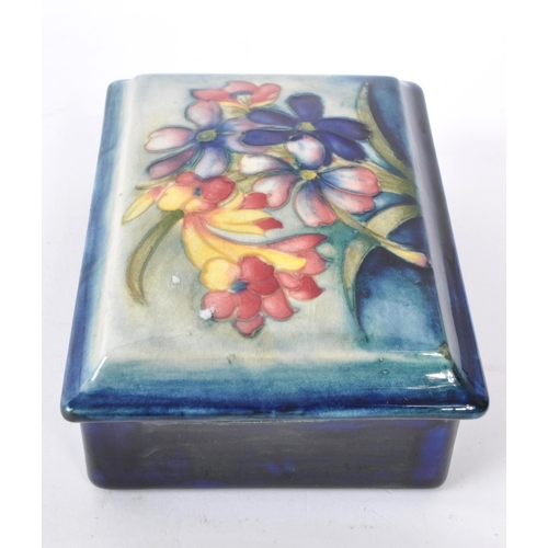 115 - Moorcraft - An early 20th Century 1930s china porcelain lidded pot of rectangular form having wild f... 