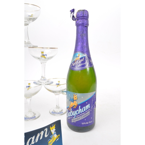 127 - Babycham - A collection of mid 20th century Babycham coupe glasses alongside a bottle of Special Edi... 