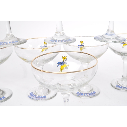 127 - Babycham - A collection of mid 20th century Babycham coupe glasses alongside a bottle of Special Edi... 