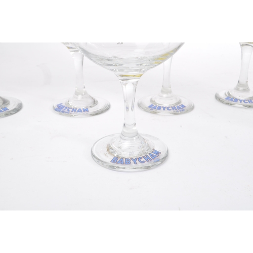 127 - Babycham - A collection of mid 20th century Babycham coupe glasses alongside a bottle of Special Edi... 