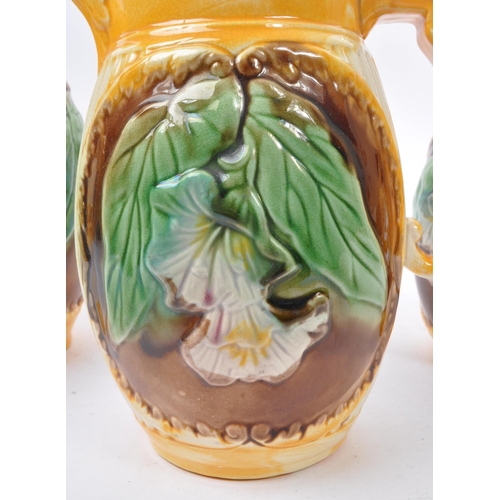 135 - A collection of three 19th Century Victorian ceramic graduating majolica  pitcher jugs George Jones ... 