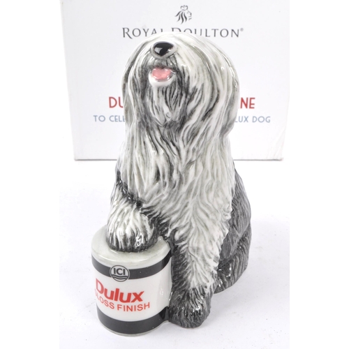 153 - Royal Doulton - A china handmade Royal Doulton figurine in the form of a Dulux dog RDA144 celebratin... 