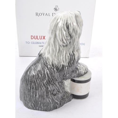 153 - Royal Doulton - A china handmade Royal Doulton figurine in the form of a Dulux dog RDA144 celebratin... 