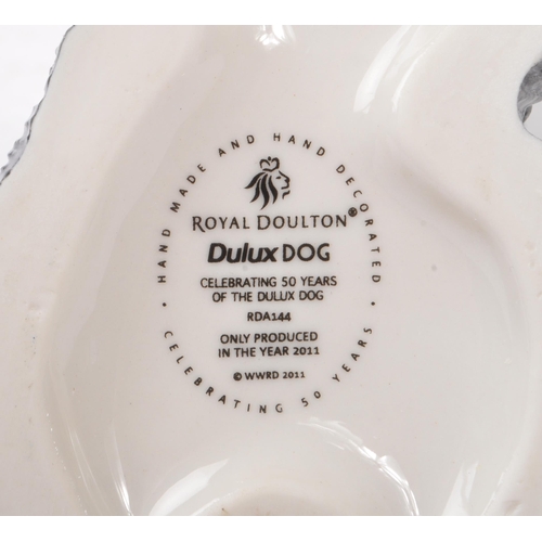 153 - Royal Doulton - A china handmade Royal Doulton figurine in the form of a Dulux dog RDA144 celebratin... 