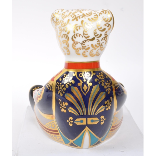 154 - Royal Crown Derby - A china porcelain ' Drummer Teddy ' paperweight in the form of a teddy bear sat ... 