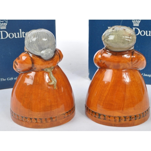 157 - Royal Doulton - A pair of late 20th Century china Royal Doulton salt and pepper figures one in the f... 