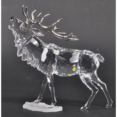 168 - Swarovski - A crystal glass Swarovski figurine / ornament in the form of a stag 291431 in standing p... 