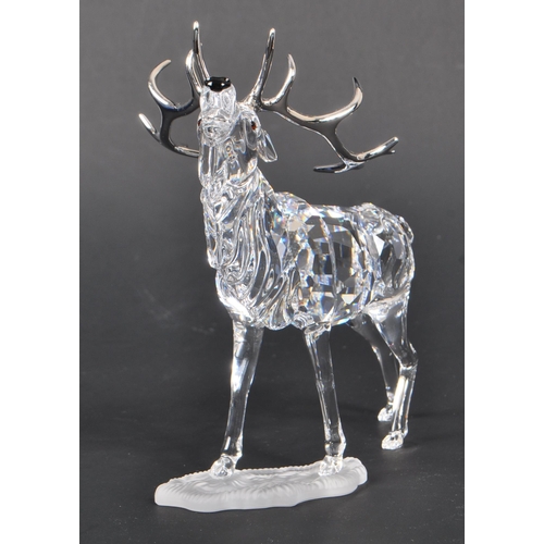 168 - Swarovski - A crystal glass Swarovski figurine / ornament in the form of a stag 291431 in standing p... 