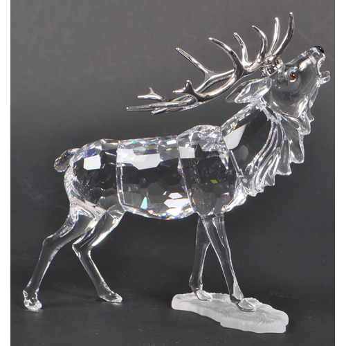 168 - Swarovski - A crystal glass Swarovski figurine / ornament in the form of a stag 291431 in standing p... 