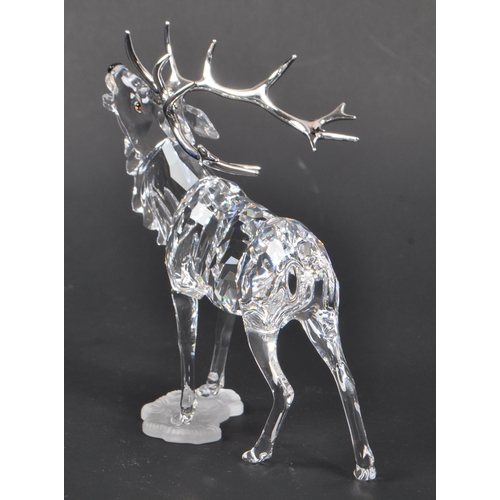 168 - Swarovski - A crystal glass Swarovski figurine / ornament in the form of a stag 291431 in standing p... 