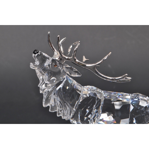 168 - Swarovski - A crystal glass Swarovski figurine / ornament in the form of a stag 291431 in standing p... 