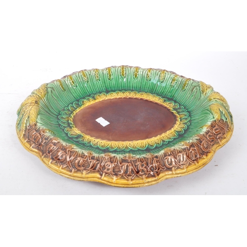 190 - A 19th Century Victorian ceramic majolica bread plate of ovoid form having wheatsheaf decoration in ... 