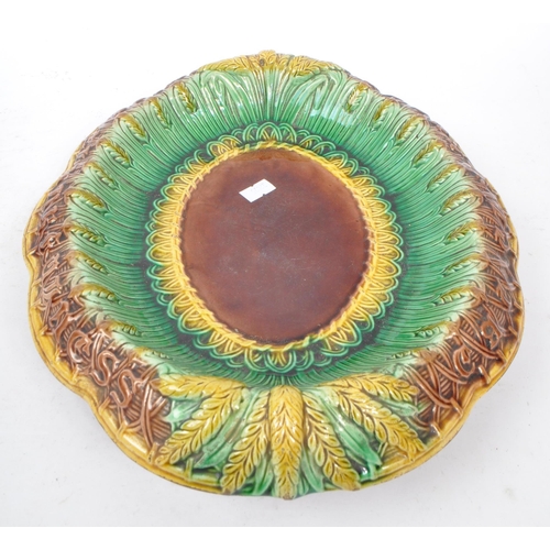 190 - A 19th Century Victorian ceramic majolica bread plate of ovoid form having wheatsheaf decoration in ... 