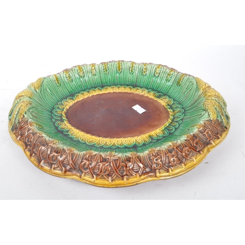 190 - A 19th Century Victorian ceramic majolica bread plate of ovoid form having wheatsheaf decoration in ... 