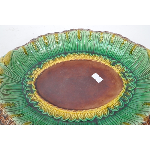 190 - A 19th Century Victorian ceramic majolica bread plate of ovoid form having wheatsheaf decoration in ... 