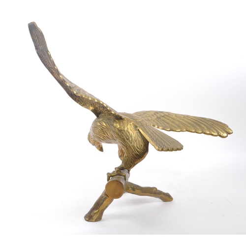 207 - A large brass figure in the form of an eagle with wings spread perched on a branch. Measuring approx... 