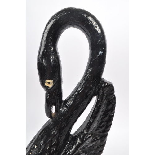 215 - A 20th Century cast iron painted door porter / door stop figure in the form of a swan with long curv... 