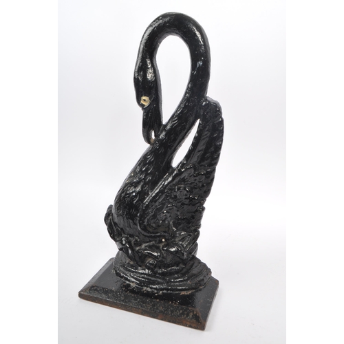 215 - A 20th Century cast iron painted door porter / door stop figure in the form of a swan with long curv... 