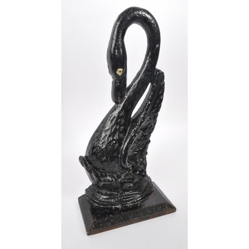 215 - A 20th Century cast iron painted door porter / door stop figure in the form of a swan with long curv... 