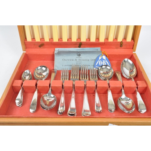 223 - Oliver & Bower - A mid Century canteen of stainless steel cutlery having faux bone / ivory handles b... 