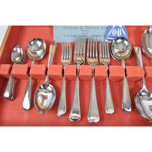 223 - Oliver & Bower - A mid Century canteen of stainless steel cutlery having faux bone / ivory handles b... 