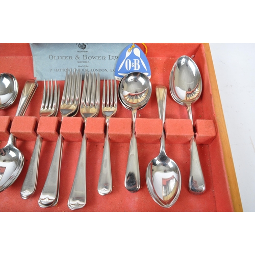 223 - Oliver & Bower - A mid Century canteen of stainless steel cutlery having faux bone / ivory handles b... 