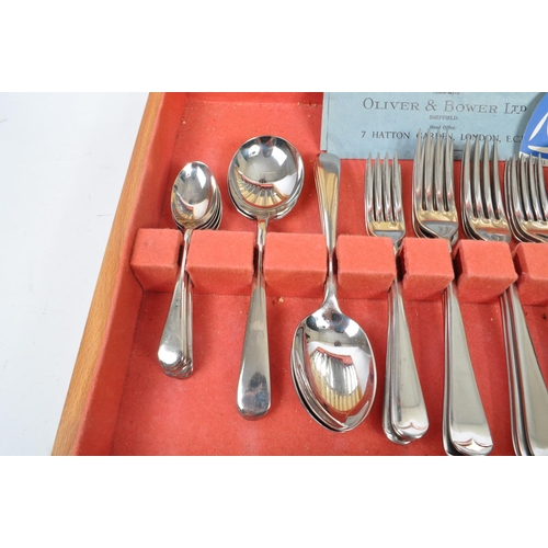 223 - Oliver & Bower - A mid Century canteen of stainless steel cutlery having faux bone / ivory handles b... 