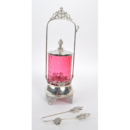 230 - A 19th century Victorian silver tone metal and cranberry glass pickle castor decanter. The castor ra... 