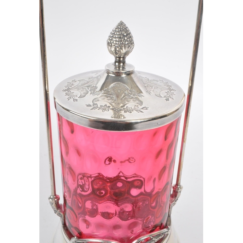 230 - A 19th century Victorian silver tone metal and cranberry glass pickle castor decanter. The castor ra... 