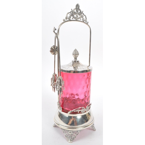 230 - A 19th century Victorian silver tone metal and cranberry glass pickle castor decanter. The castor ra... 