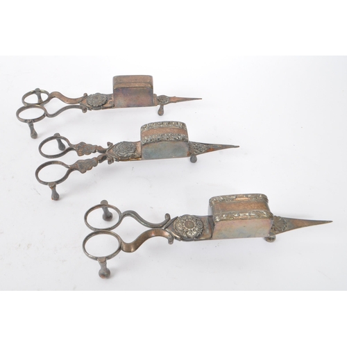 231 - A collection of early Victorian 19th century metal candle snuffers, wick cutters and clip. With orna... 