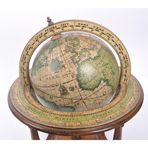 238 - A vintage 20th century desktop terrestrial world globe. The globe supported in a walnut wooden stand... 