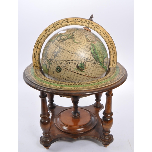 238 - A vintage 20th century desktop terrestrial world globe. The globe supported in a walnut wooden stand... 